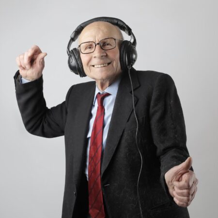 cheerful elderly man listening to music in headphones
